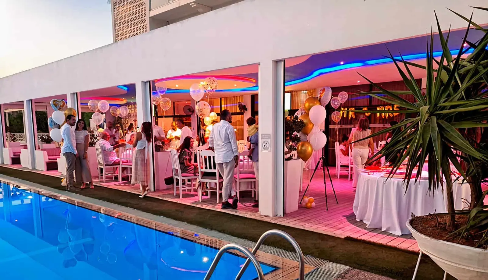 A party set up beside the pool at night