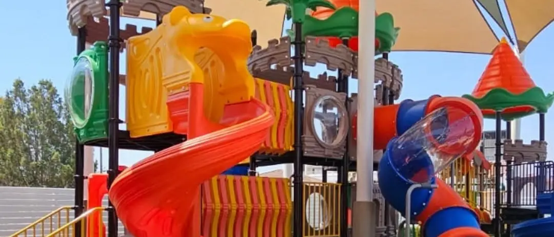 The children’s playground with slides and a shaded roof