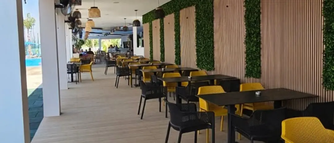 The covered terrace of the lounge with tables and chairs