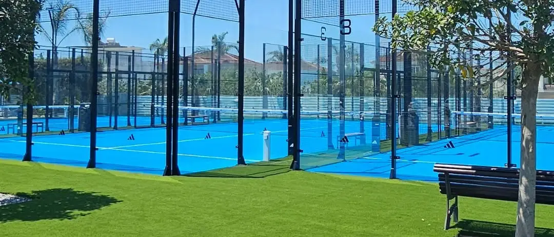 A padel court and net on a blue surface